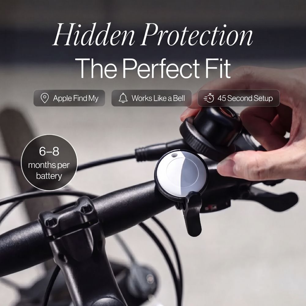 Hand holding a bike handlebar with a device labeled 'Hidden Protection The Perfect Fit' on a blurred background.